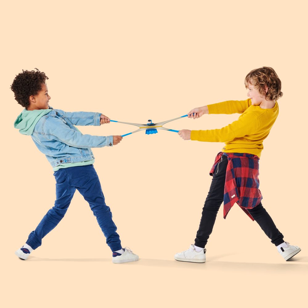 Two kids stretching a Goo Jitzu hero between them